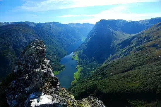 How Openai’s Latest Breakthrough Challenges the ‘Cure-All’ AI Myth View from a rocky mountain outcrop over a narrow river or fjord winding through a steep green valley under a blue sky
