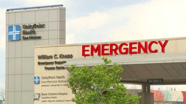 Revolutionary Shift: Des Moines Paramedics Now Administer Blood On Scene To Save Lives Hospital emergency entrance with large red “EMERGENCY” sign and UnityPoint Health Iowa Methodist Medical Center signage; caption at bottom reads, “Revolutionary Shift: Des Moines Paramedics Now Administer Blood On Scene To Save Lives”