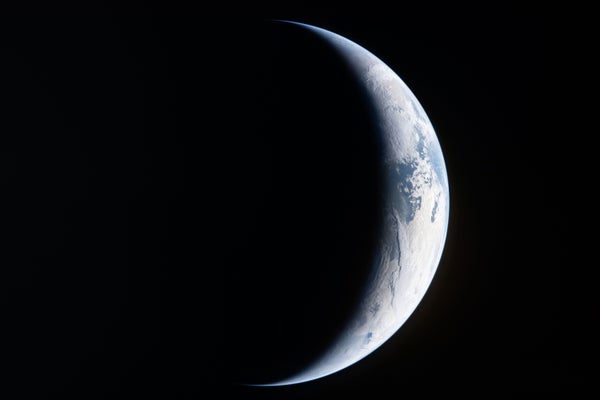 NASA’s Artemis II: Countdown to a Historic Lunar Flyby Thin crescent view of Earth against black space, with the title text “NASA’s Artemis II: Countdown to a Historic Lunar Flyby” at the bottom