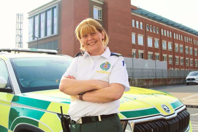 Dublin Mum Reinvents Herself As Paramedic at 40 After Son’s Life-Changing Accident Woman in paramedic uniform standing with arms crossed in front of an ambulance, with a red brick building in the background and the text: Dublin Mum Reinvents Herself As Paramedic at 40 After Son's Life-Changing Accident